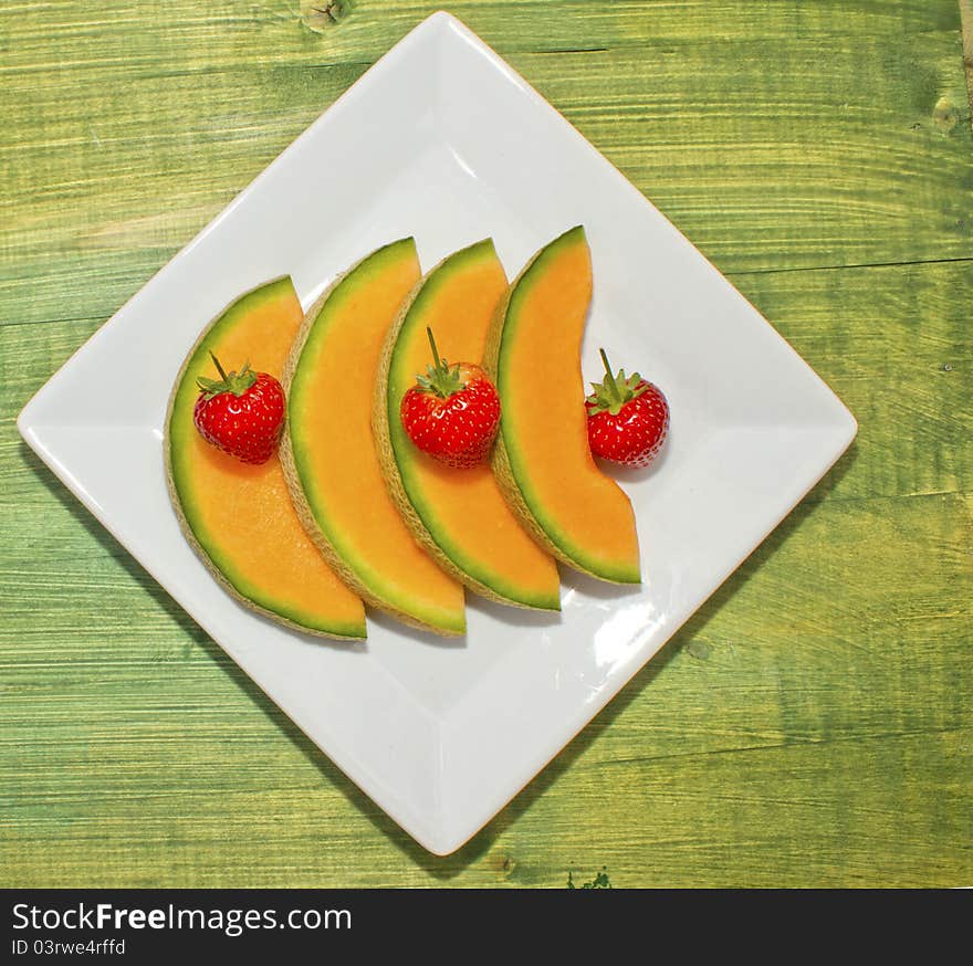 Melon Slices on White Plate. Melon Slices on White Plate