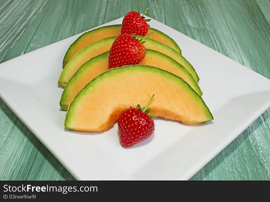 Melon Slices on White Plate. Melon Slices on White Plate