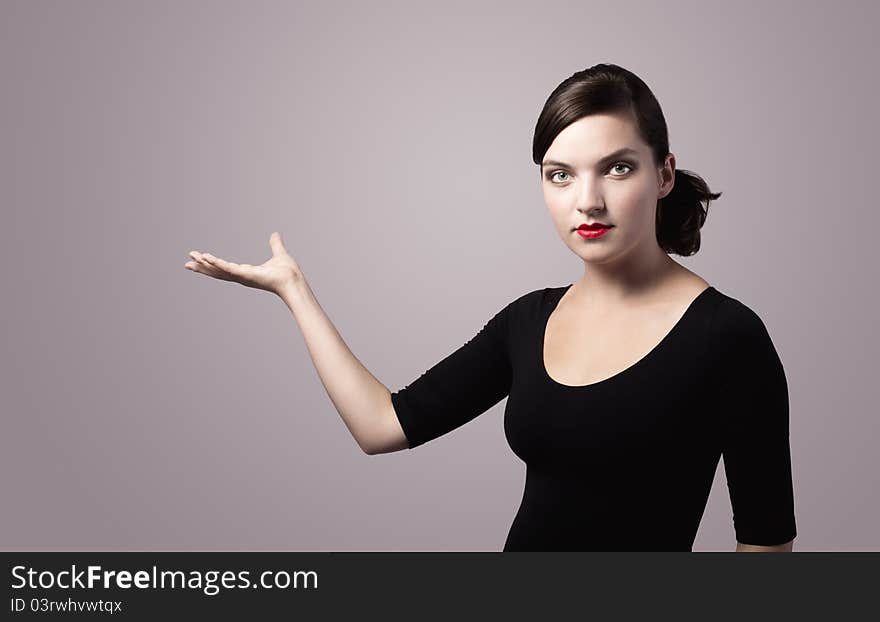 Woman presenting something imaginary with her right hand, vintage colors