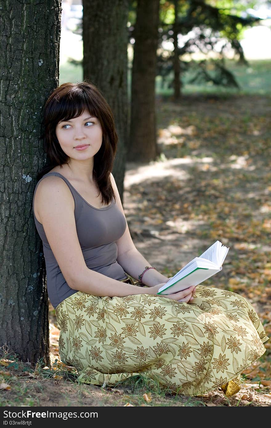 Girl reading book in park