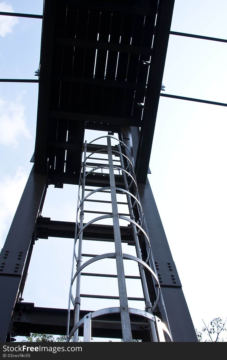 Enclosed metal ladder on a steel structure for safety and prevent from fall. Enclosed metal ladder on a steel structure for safety and prevent from fall