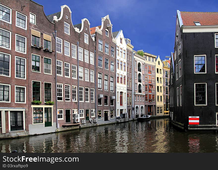 Amsterdam houses facade with water and blue sky. Amsterdam houses facade with water and blue sky