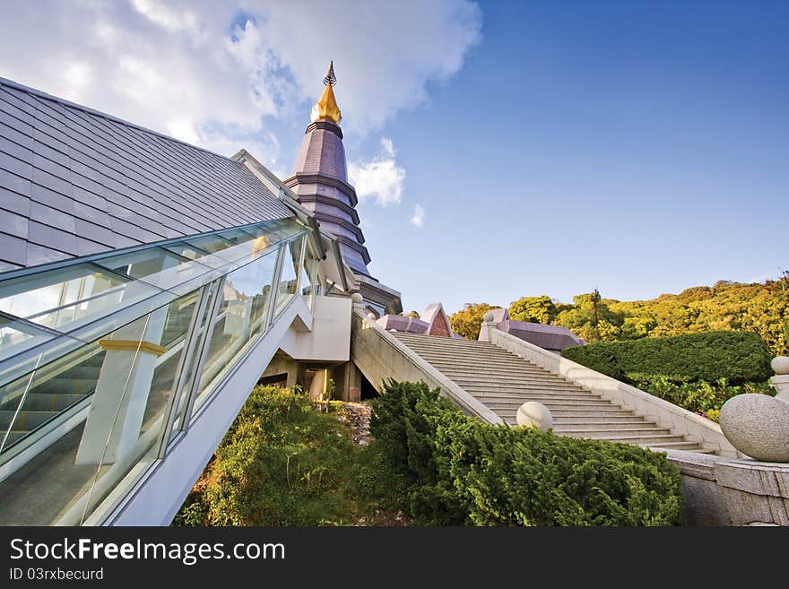 This place is pagoda which located at Doi Inthanon, Chiangmai, Thailand. Escalator that located at the left side of picture was build for old people. This place is pagoda which located at Doi Inthanon, Chiangmai, Thailand. Escalator that located at the left side of picture was build for old people.