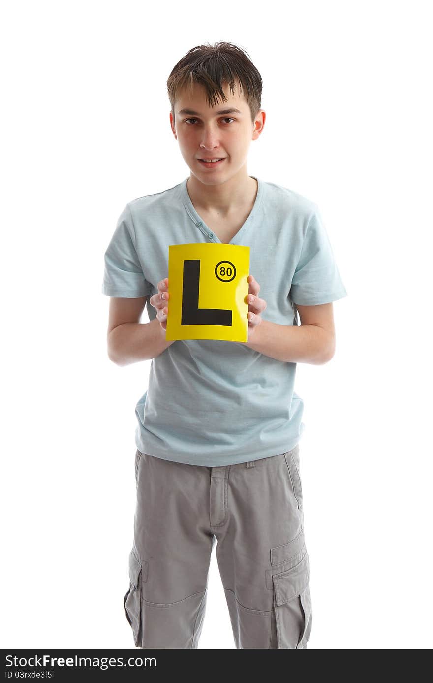 Teenage boy holding L plates (or other sign). White background. Teenage boy holding L plates (or other sign). White background.