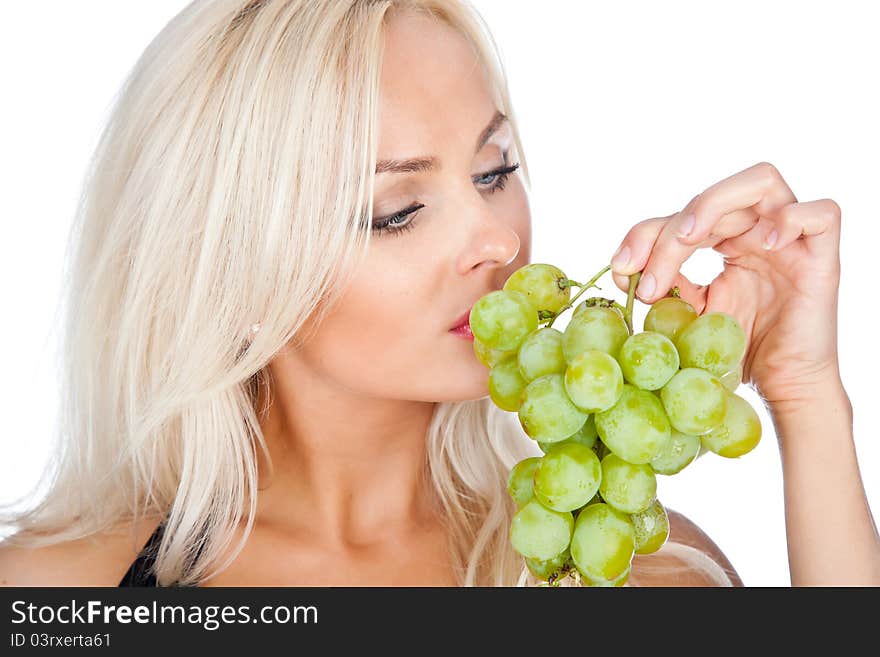 Blonde in black bathing suit eating grapes. Blonde in black bathing suit eating grapes