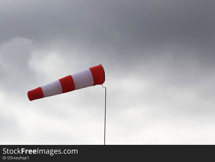 Windsock close-up against the sky with clouds