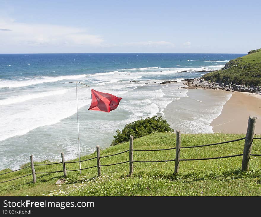 Red flag on the beach in asturias, Spain