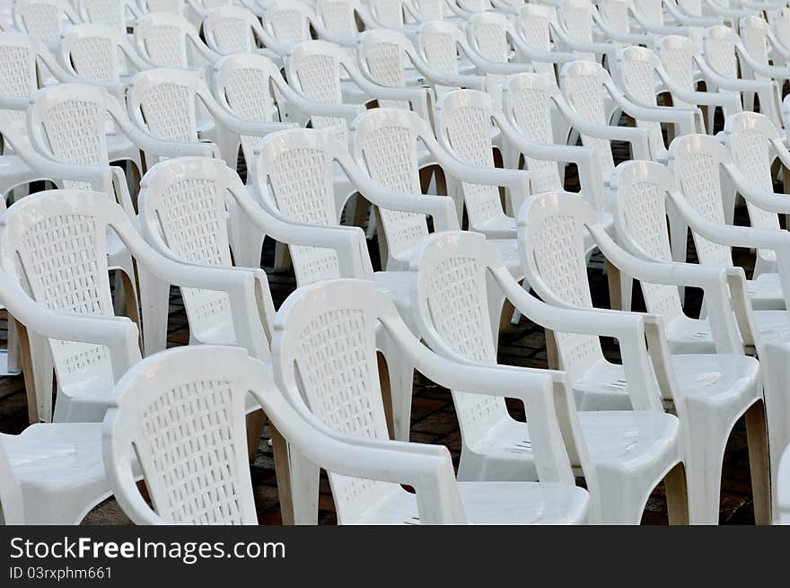 White plastic empty chairs in an open air cinema or theatre. White plastic empty chairs in an open air cinema or theatre