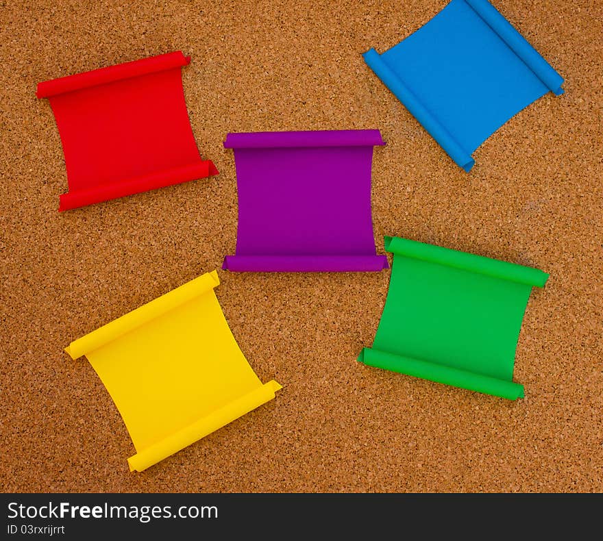 Collection of colorful note papers on cork board