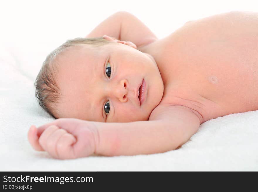 Newborn cute baby on white blanket. Newborn cute baby on white blanket