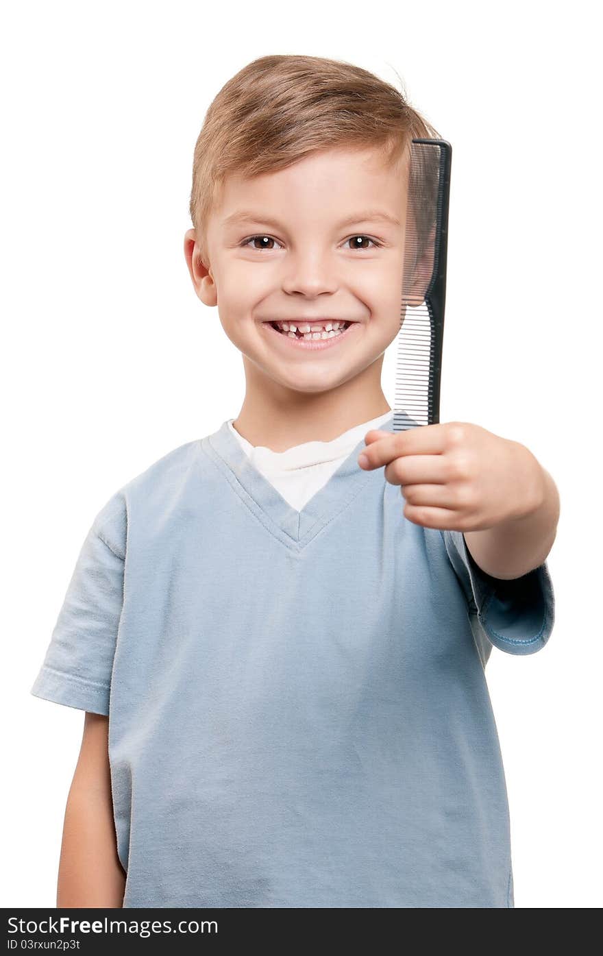 Portrait of a little boy holding a comb over white background. Portrait of a little boy holding a comb over white background