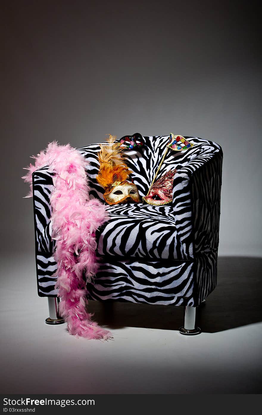 Image shoeing brightly coloured masquerade masks on retro style chair. Image shoeing brightly coloured masquerade masks on retro style chair