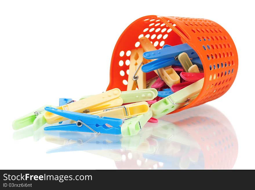 Pile of clothes-pegs of different colors on a white background. Pile of clothes-pegs of different colors on a white background