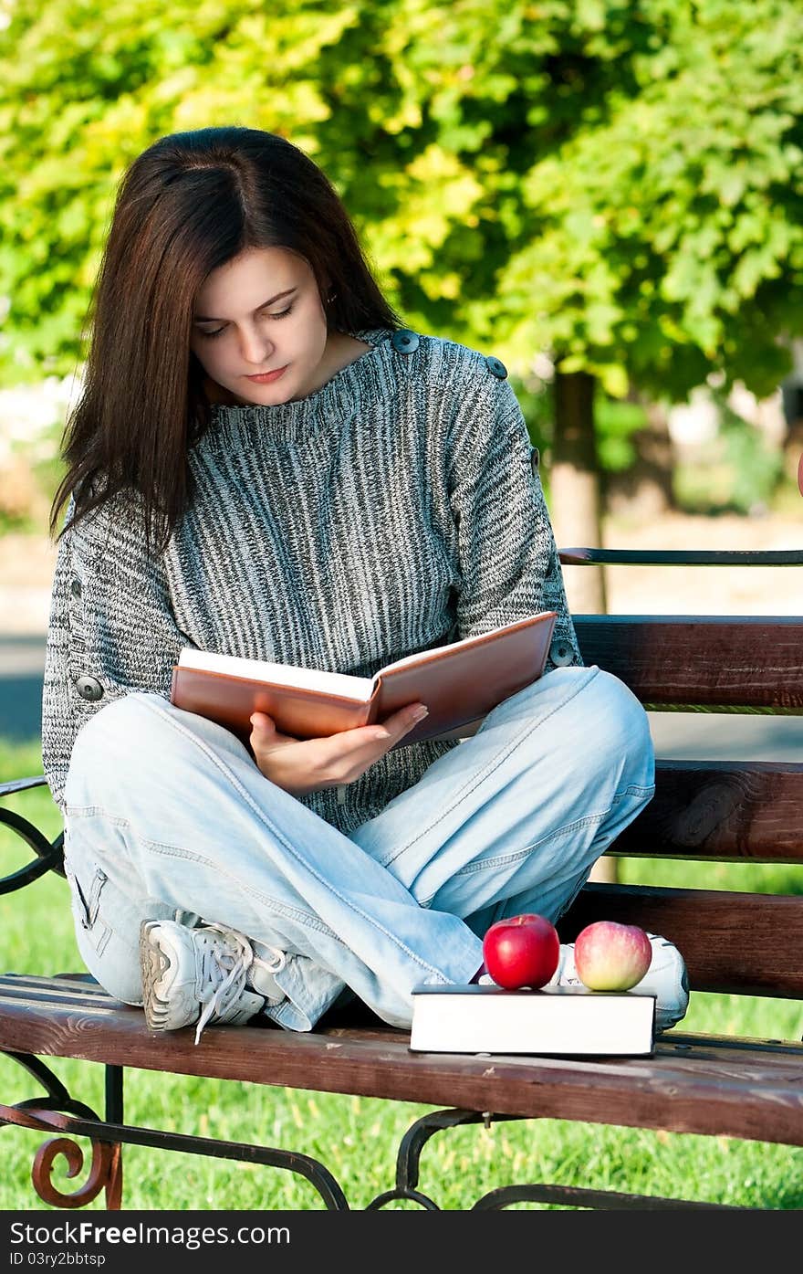 Portrait of a young female student with books at the campus