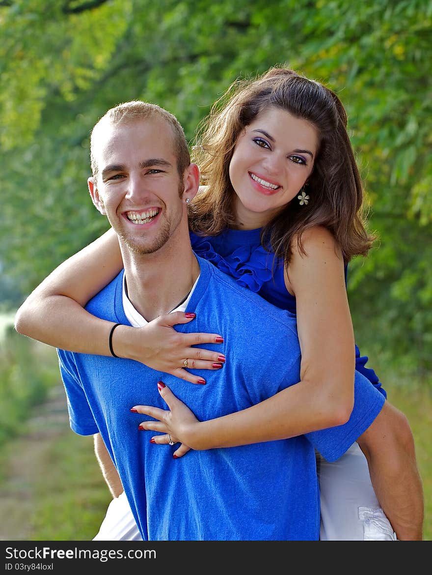 Couple in a piggy - back embrace