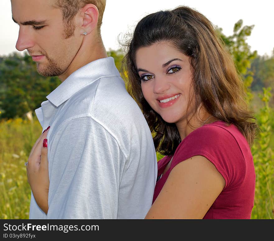 Young couple posing in a warm embrace. Young couple posing in a warm embrace