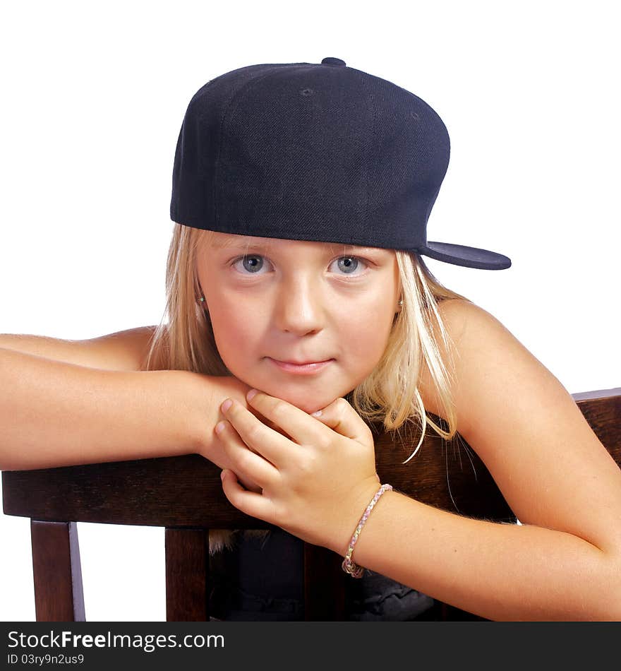 Young girl leaning on a chair with a smirk on her face. Young girl leaning on a chair with a smirk on her face