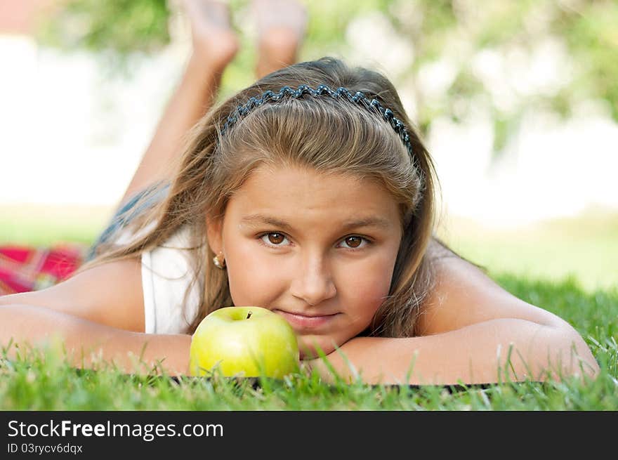 Portrait of little girl with green apple outdoor. Portrait of little girl with green apple outdoor