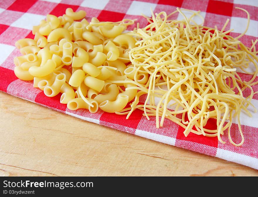 Raw italian pasta on red white towel. Raw italian pasta on red white towel