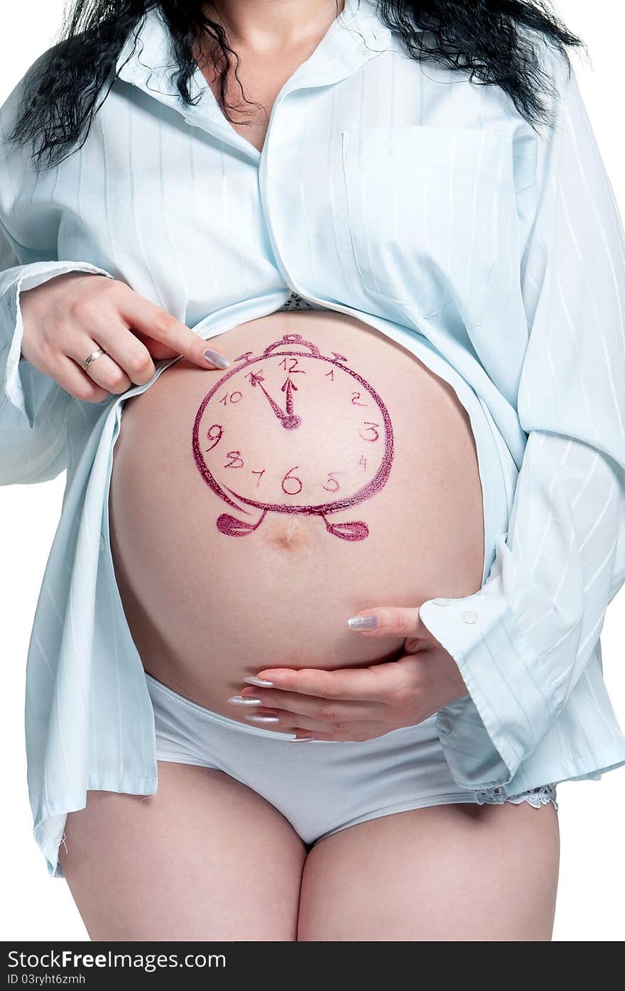 Tummy of pregnant woman with funny drawing over white background. Tummy of pregnant woman with funny drawing over white background