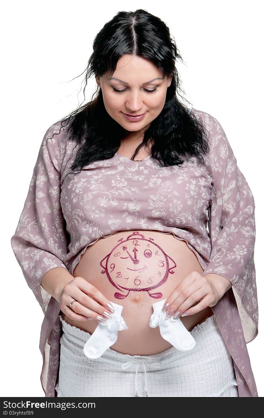 Tummy of pregnant woman with funny drawing over white background. Tummy of pregnant woman with funny drawing over white background