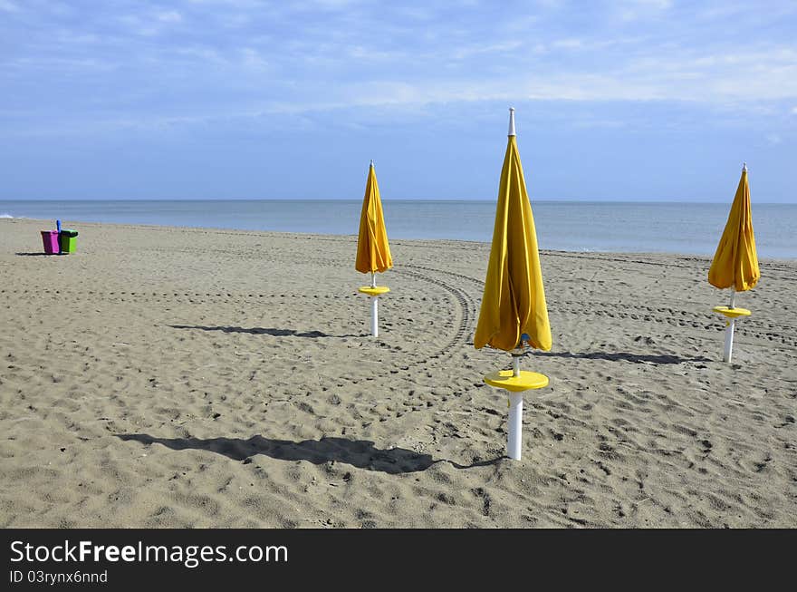 Yellow umbrellas on the beach in Civitanova - Italy. Yellow umbrellas on the beach in Civitanova - Italy