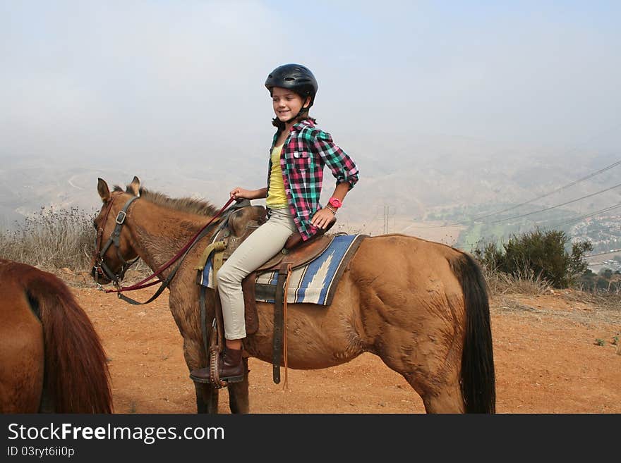 Girl sitting on tp of a horse. Girl sitting on tp of a horse.