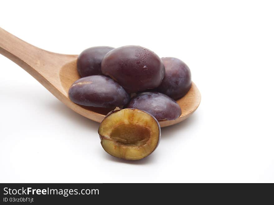 Plums  on wooden spoon