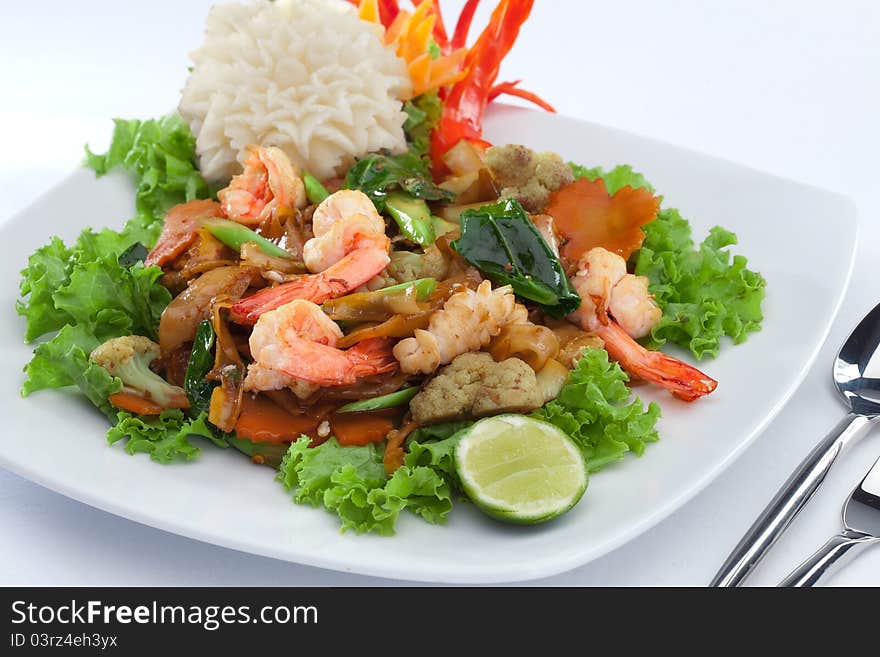 Close up view of nice shrimps with vegetables on white back. Close up view of nice shrimps with vegetables on white back