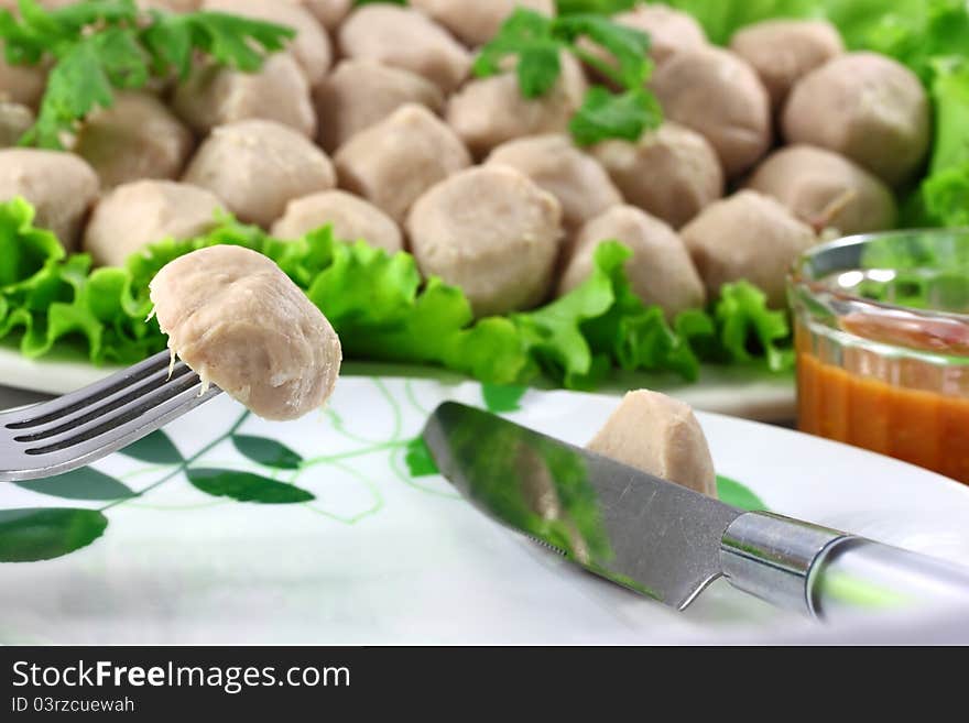 Meatball Pork on Vegetables salad in background white.