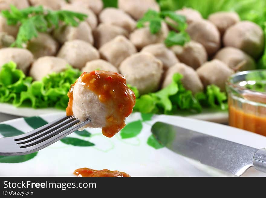 Meatball Pork on Vegetables salad in background white.