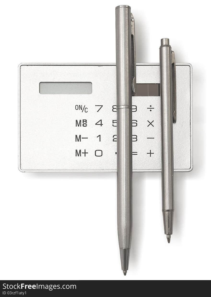 Two metal ball pens and calculator on a white background. Two metal ball pens and calculator on a white background