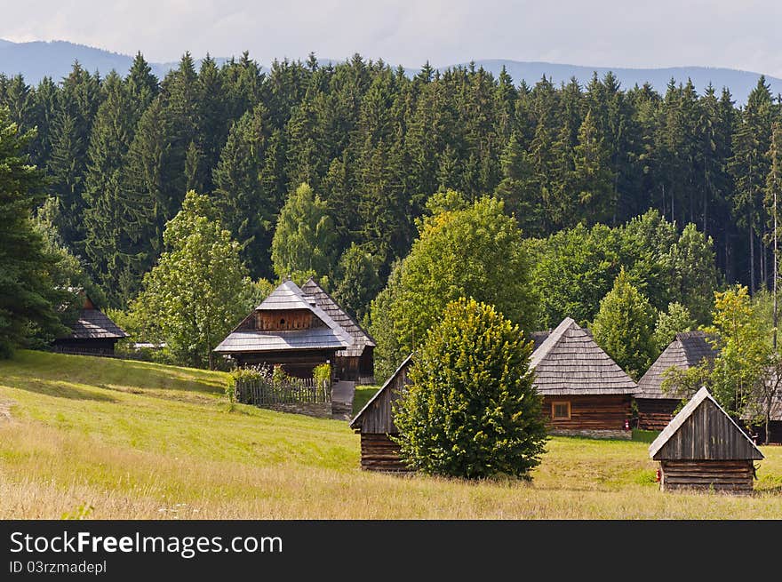 Photo of the traditional slovak village with a few timbers and greenery around