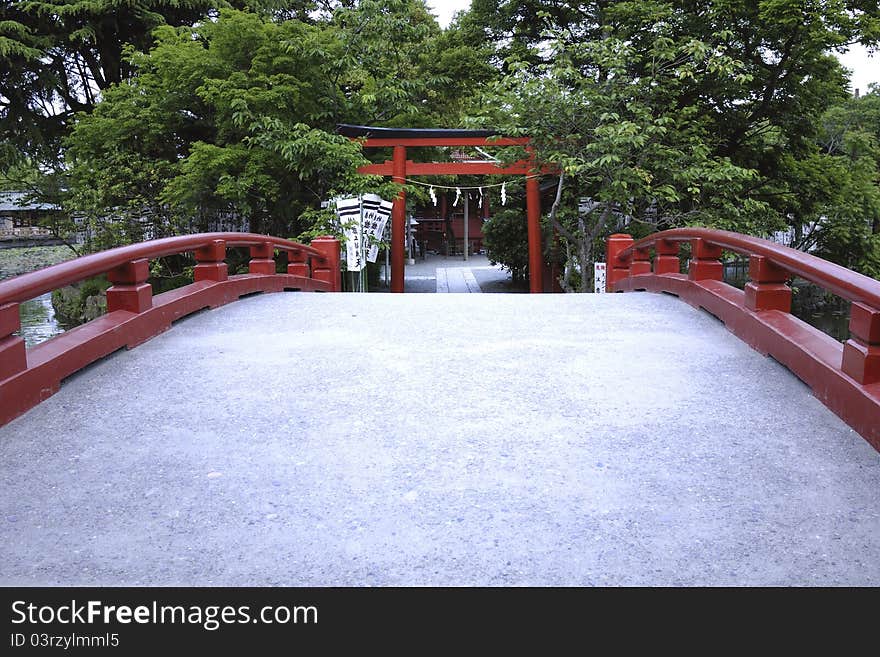 Way over Japanese bridge leads to temple's gate. Way over Japanese bridge leads to temple's gate