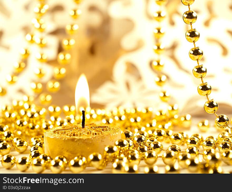 Christmas decoration, gold holiday background with candle & snowflake.