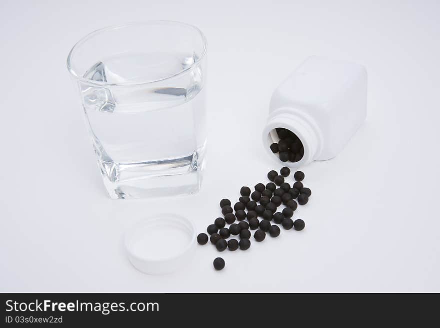 Herbal medicine pill with a glass water