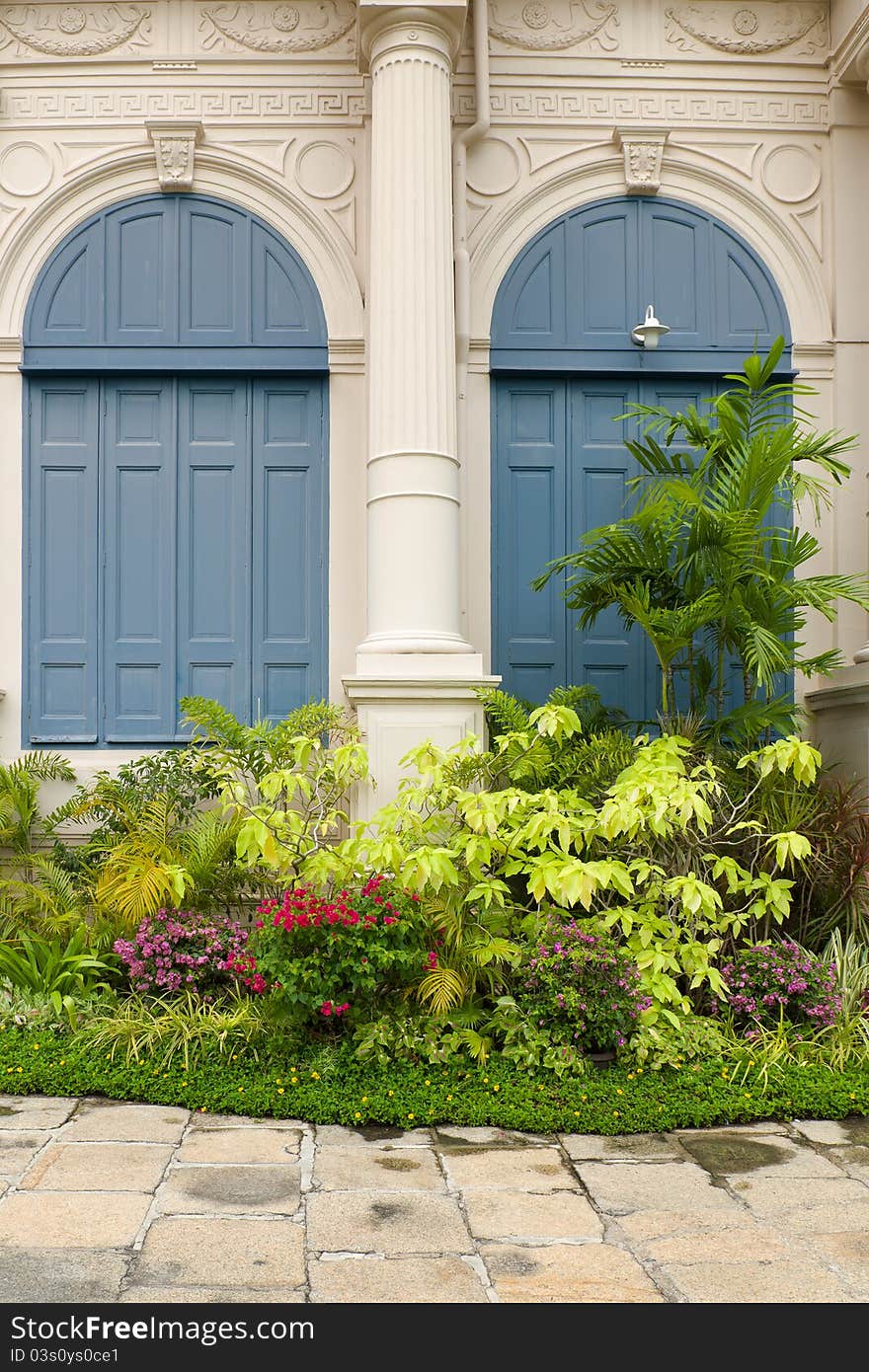 Garden in front of the building and blue wood window