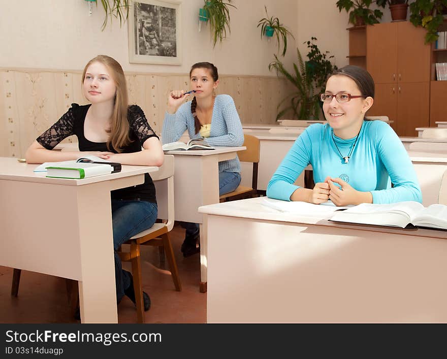 Schoolgirls in class in a classroom. Schoolgirls in class in a classroom