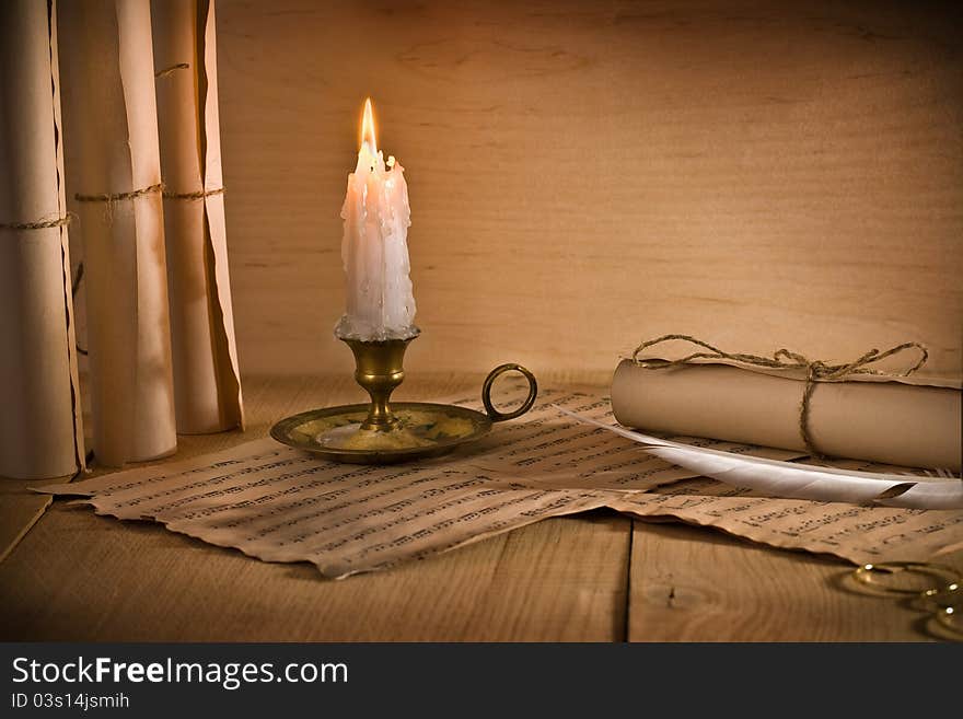 Studio shot
musical notes and burning candle on old table. Studio shot
musical notes and burning candle on old table