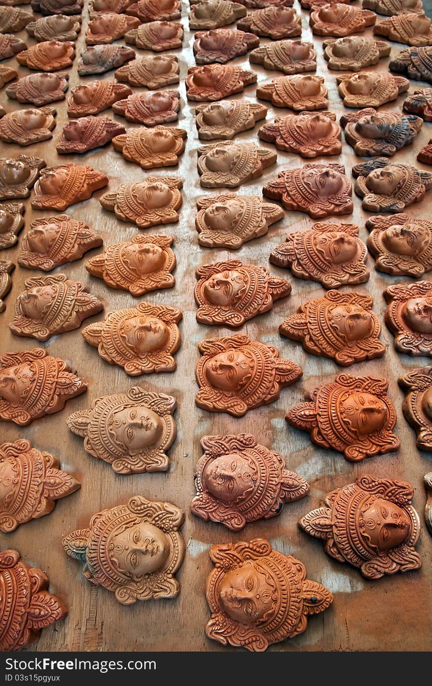 Many multi colored clay heads of Goddess Durga arranged for sale for the Dasara festival. Many multi colored clay heads of Goddess Durga arranged for sale for the Dasara festival