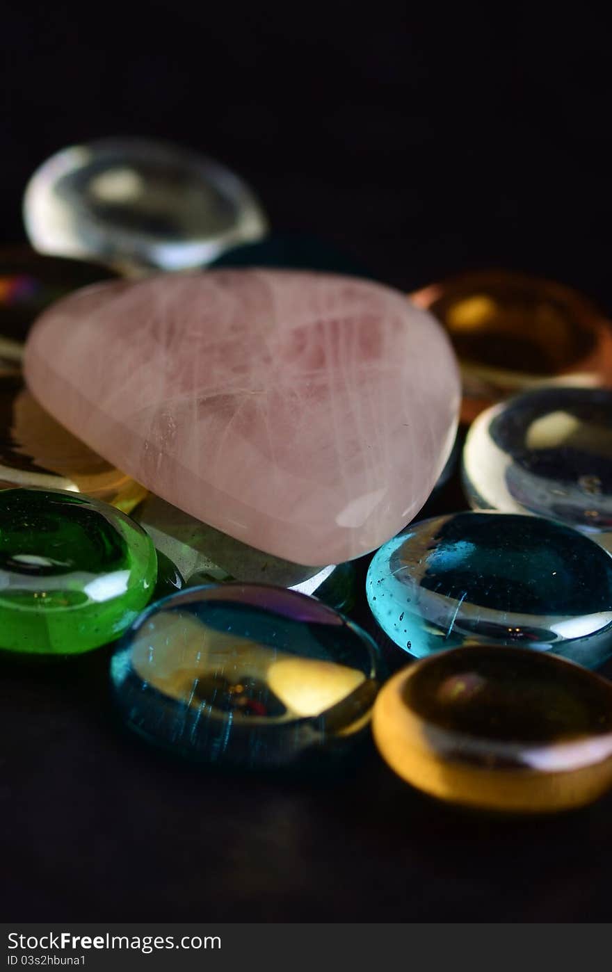 Rose Quarts on colorful glass rocks