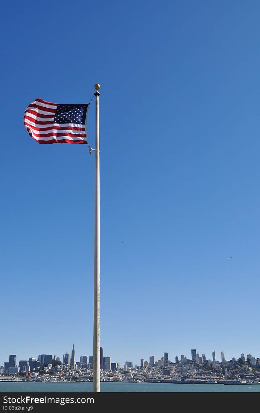 Flag of the United States of America against San Francisco skyline. Flag of the United States of America against San Francisco skyline