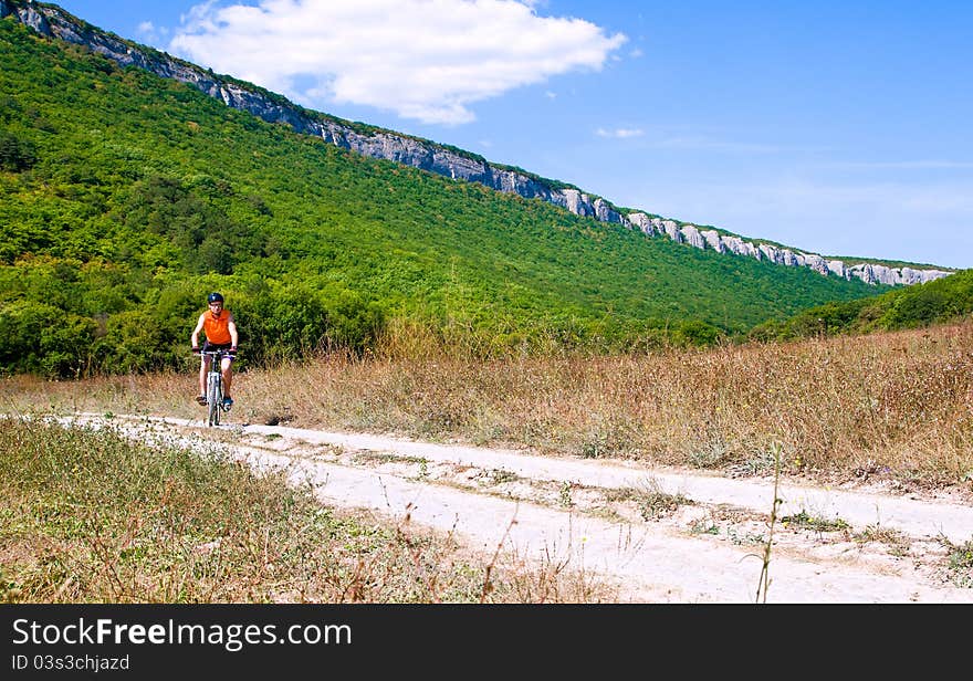 Young sportive man with his black muontain-bike. Young sportive man with his black muontain-bike