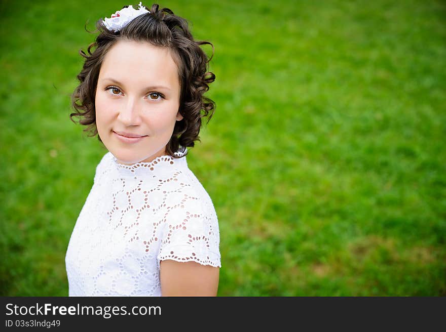 Portrait of beautiful young woman on the green grass background. Portrait of beautiful young woman on the green grass background