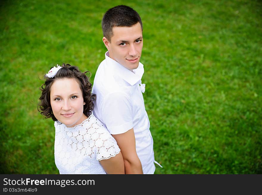 Portrait of beautiful young women and men on the green grass background. Portrait of beautiful young women and men on the green grass background