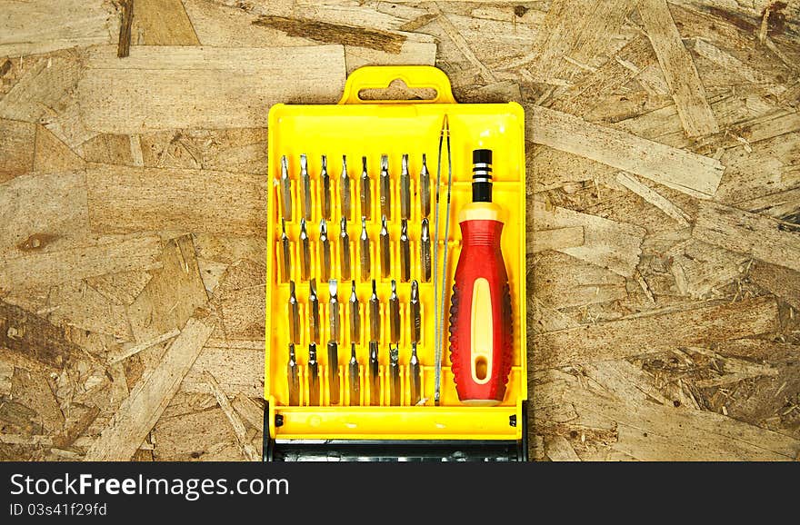 Put a box set of screwdrivers.Placed on a wooden floor.