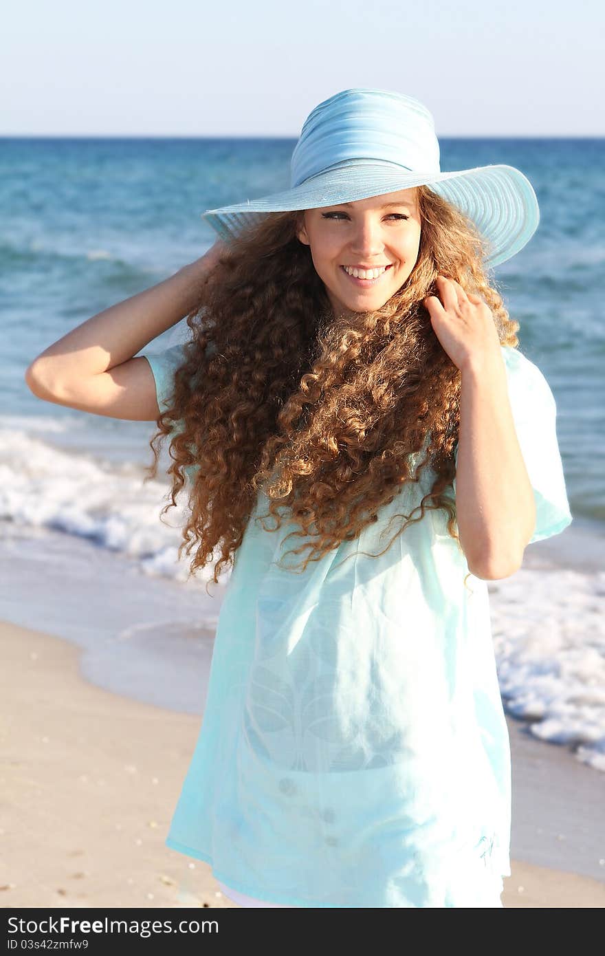 Young happy woman on sea background