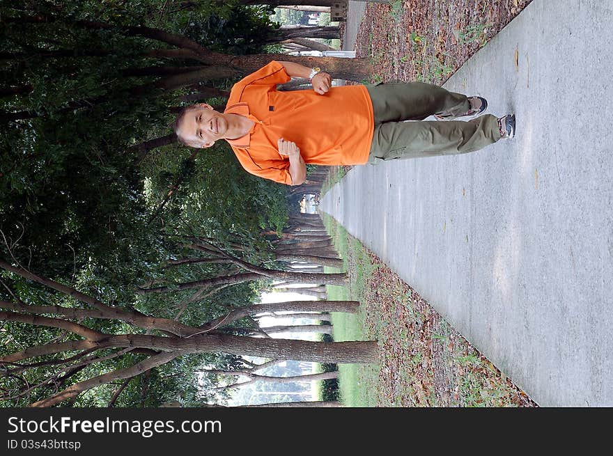 A Runner who Running under the tree-lined for Health care. A Runner who Running under the tree-lined for Health care