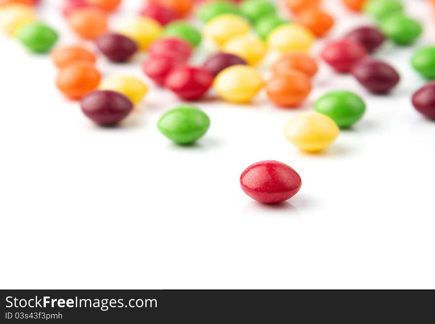 Colorful fruit candies on white background