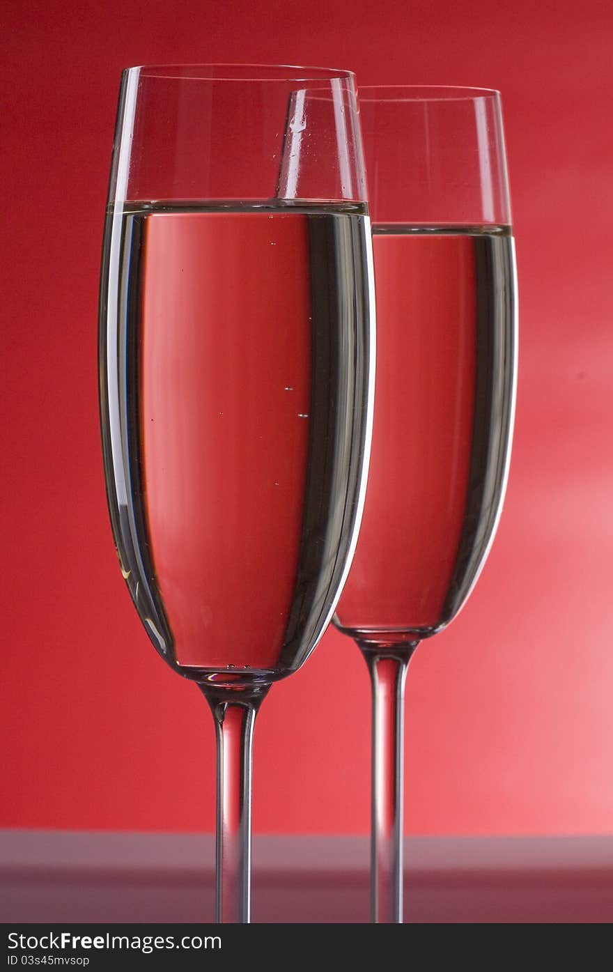 Two wineglasses of champagne  over colored  background